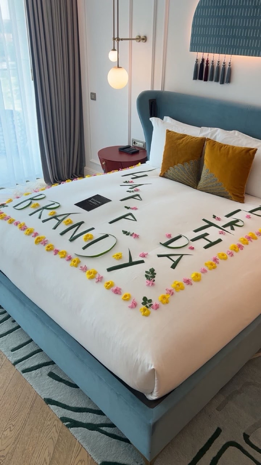 A birthday bed styled with fresh flowers