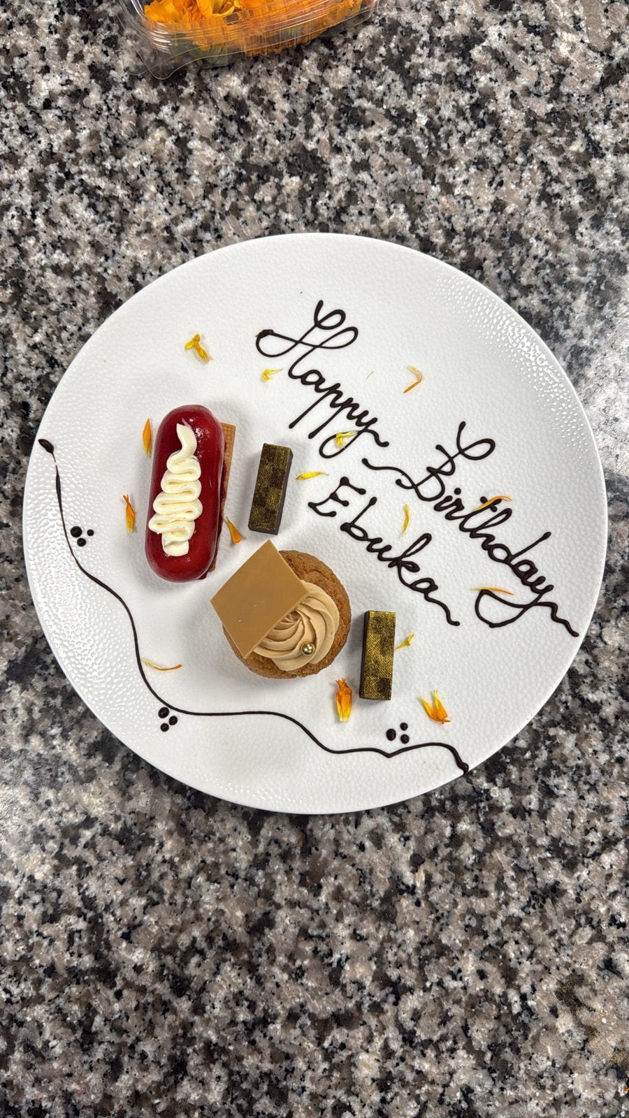 A plated patisserie dessert with a birthday message in chocolate