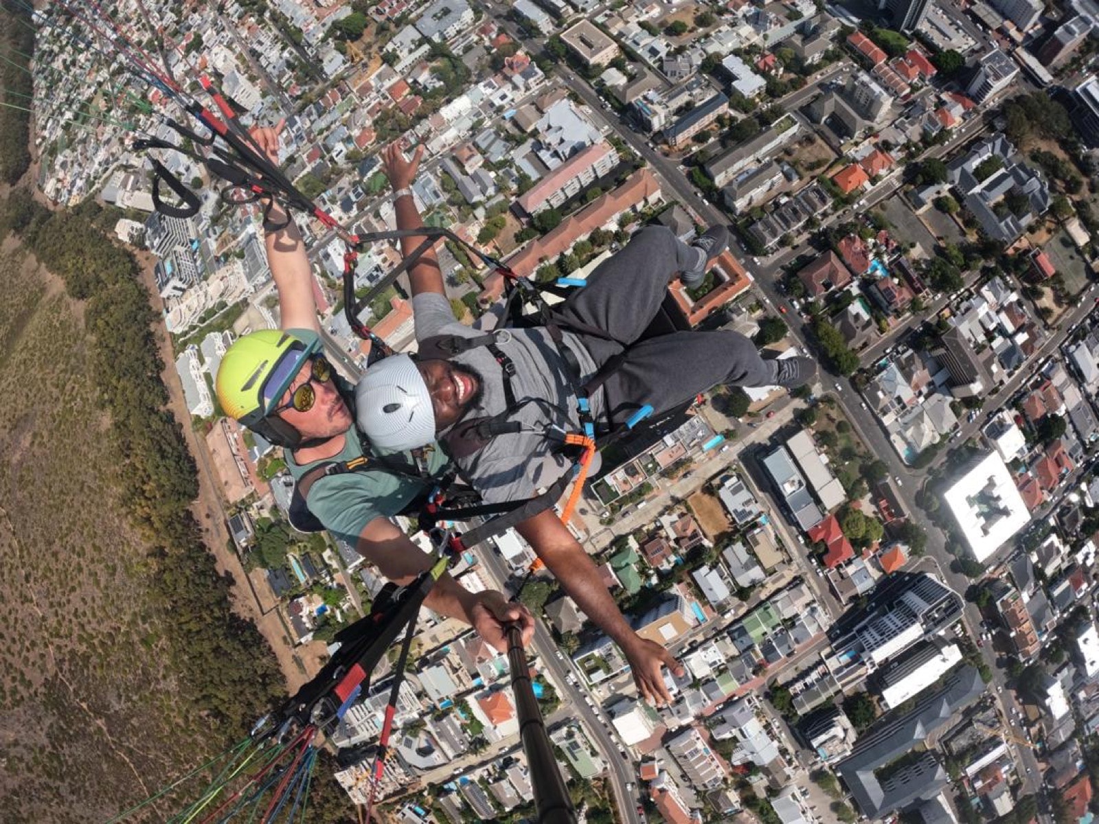 A client paragliding over Cape Town